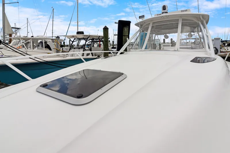  Yacht Photos Pics 2004 Intrepid 377 Walkaround boat docked at marina under blue sky.