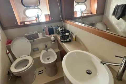  Yacht Photos Pics Bathroom interior of 2008 Ferretti Yachts 592 with modern fixtures and porthole windows.