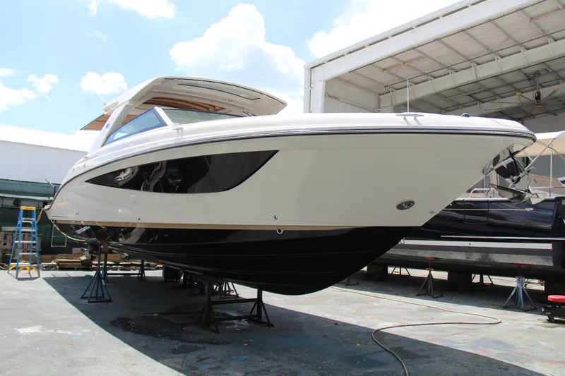  Yacht Photos Pics 2019 Sea Ray SLX 400 boat on stands in a marina, under a clear sky.