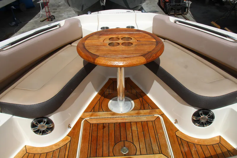  Yacht Photos Pics 2019 Sea Ray SLX 400 boat interior with wooden table and cushioned seating.