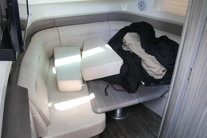  Yacht Photos Pics 2019 Sea Ray SLX 400 interior with beige seating and cushions, showcasing a cozy cabin area.