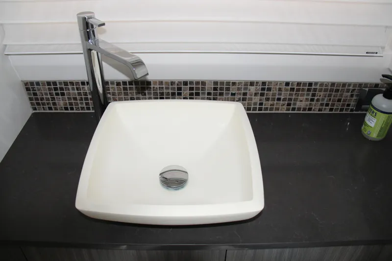  Yacht Photos Pics Modern square sink with chrome faucet on dark countertop, Sea Ray SLX 400, 2019.