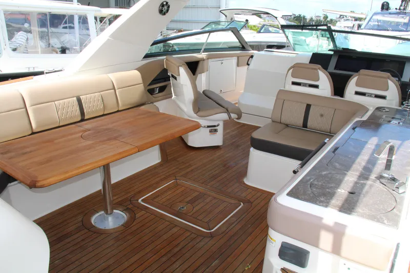  Yacht Photos Pics 2019 Sea Ray SLX 400 interior with wooden deck, seating, and table.