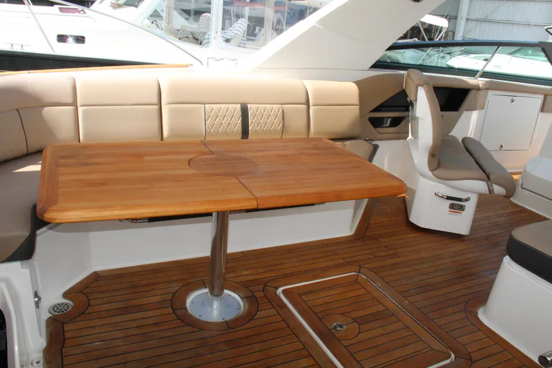  Yacht Photos Pics 2019 Sea Ray SLX 400 interior with wooden table and beige seating.