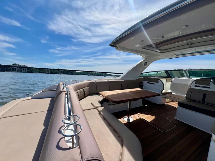  Yacht Photos Pics 2019 Sea Ray SLX 400 boat with spacious seating and table on a sunny day.
