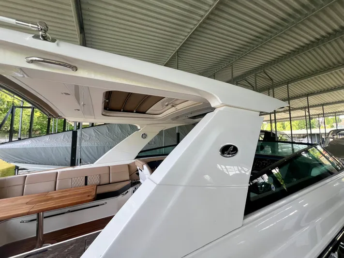  Yacht Photos Pics 2019 Sea Ray SLX 400 boat with sleek design under a covered dock.