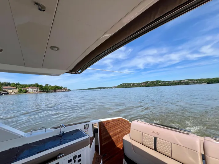  Yacht Photos Pics 2019 Sea Ray SLX 400 boat with open deck, overlooking serene lake and blue sky.