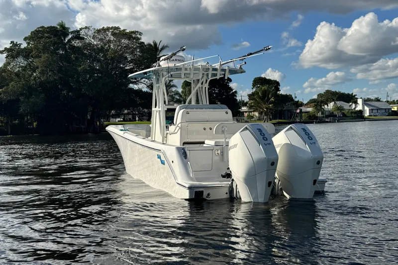  Yacht Photos Pics 2024 SeaVee 290B boat with dual Mercury engines on a calm waterway.