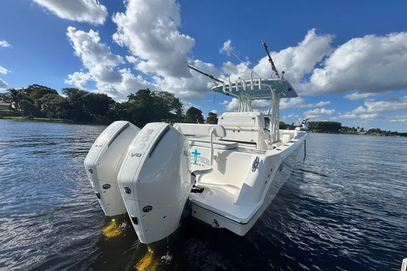  Yacht Photos Pics 2024 SeaVee 290B boat with dual engines on a sunny day, cruising on calm waters.