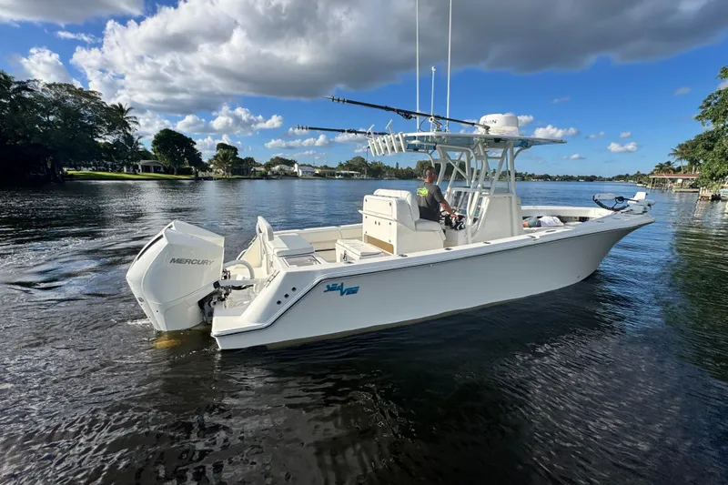 Yacht Photos Pics 2024 SeaVee 290B boat on calm water, featuring Mercury outboard engine.