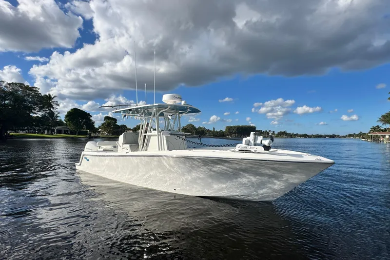  Yacht Photos Pics 2024 SeaVee 290B boat on calm water under a partly cloudy sky.