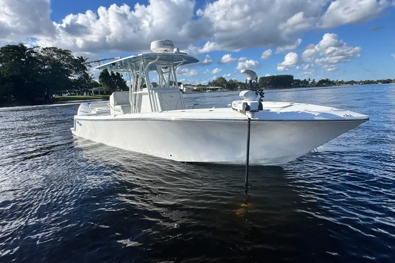  Yacht Photos Pics 2024 SeaVee 290B boat on calm water under a partly cloudy sky.