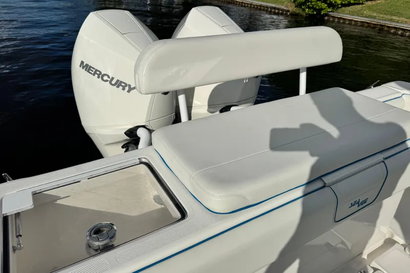  Yacht Photos Pics 2024 SeaVee 290B boat with Mercury engines, featuring sleek white seating and storage.