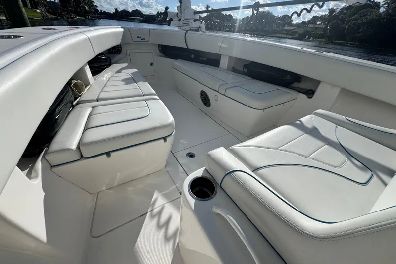 Yacht Photos Pics 2024 SeaVee 290B boat interior with white cushioned seating and cup holder.