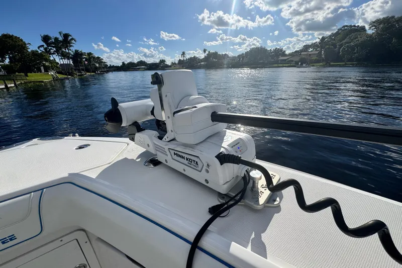  Yacht Photos Pics 2024 SeaVee 290B boat with Minn Kota motor on a sunny day by the water.