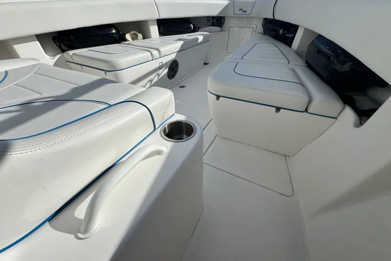  Yacht Photos Pics 2024 SeaVee 290B boat interior with white cushioned seating and cup holder.