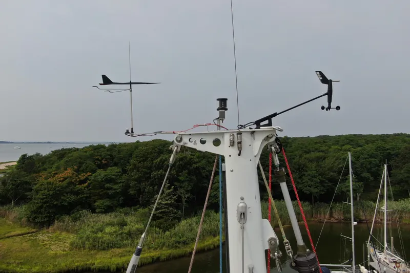 Mara Yacht Photos Pics Sailboat mast with weather instruments, Able Apogee 50, 1998, overlooking lush green landscape and water.