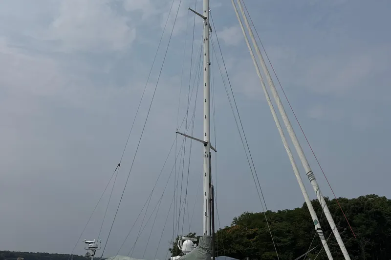 Mara Yacht Photos Pics Tall mast of 1998 Able Apogee 50 sailboat against cloudy sky.