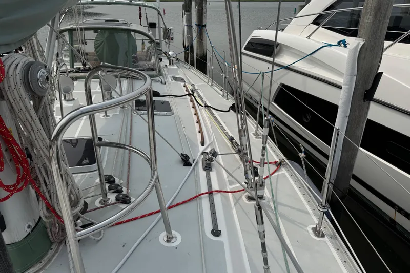 Mara Yacht Photos Pics Deck view of a 1998 Able Apogee 50 sailboat docked beside a yacht.