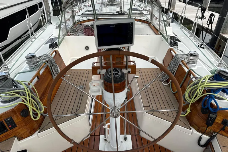 Mara Yacht Photos Pics Cockpit of 1998 Able Apogee 50 sailboat with wooden wheel and navigation equipment.