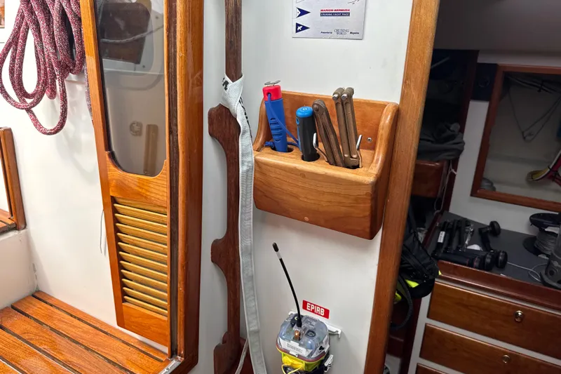 Mara Yacht Photos Pics Interior of 1998 Able Apogee 50 sailboat with wooden accents and tool storage.