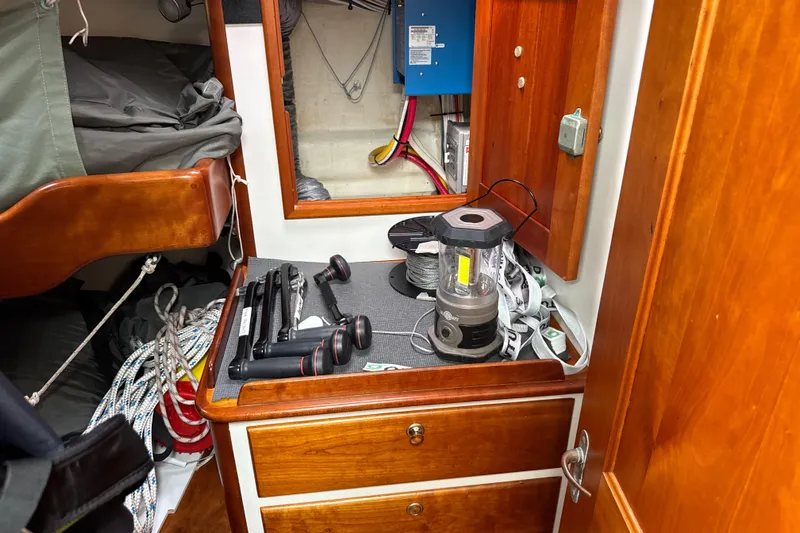 Mara Yacht Photos Pics Interior of 1998 Able Apogee 50 sailboat with tools and lantern on wooden cabinet.