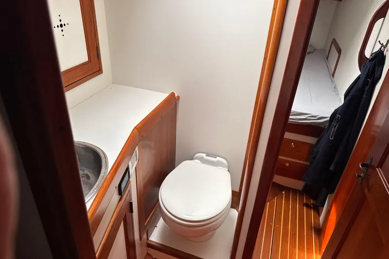 Mara Yacht Photos Pics Compact bathroom in 1998 Able Apogee 50 yacht with wooden accents and adjacent cabin.