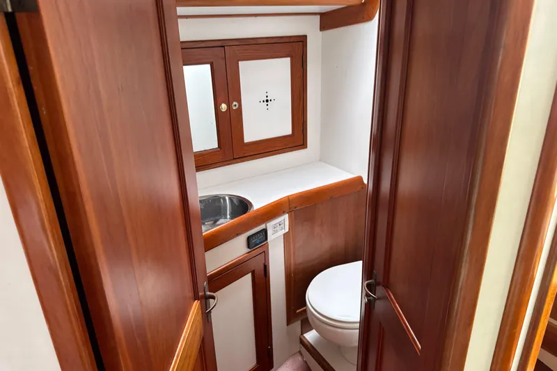Mara Yacht Photos Pics 1998 Able Apogee 50 yacht bathroom with wooden cabinetry and compact design.