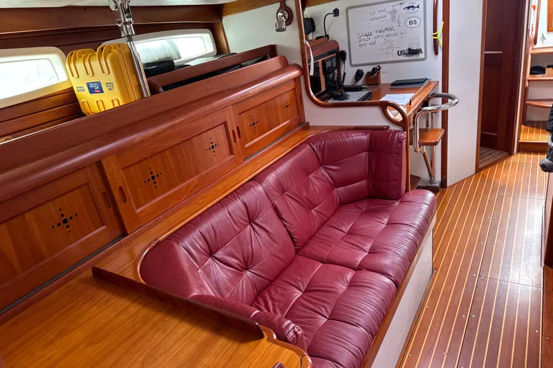 Mara Yacht Photos Pics Luxurious interior of 1998 Able Apogee 50 yacht with red leather seating and wooden finishes.