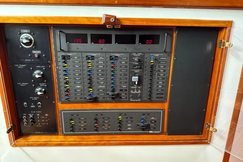 Mara Yacht Photos Pics Electrical control panel on a 1998 Able Apogee 50 yacht, featuring switches and gauges.