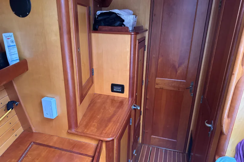 Mara Yacht Photos Pics Interior of 1998 Able Apogee 50 yacht with wooden cabinetry and door.