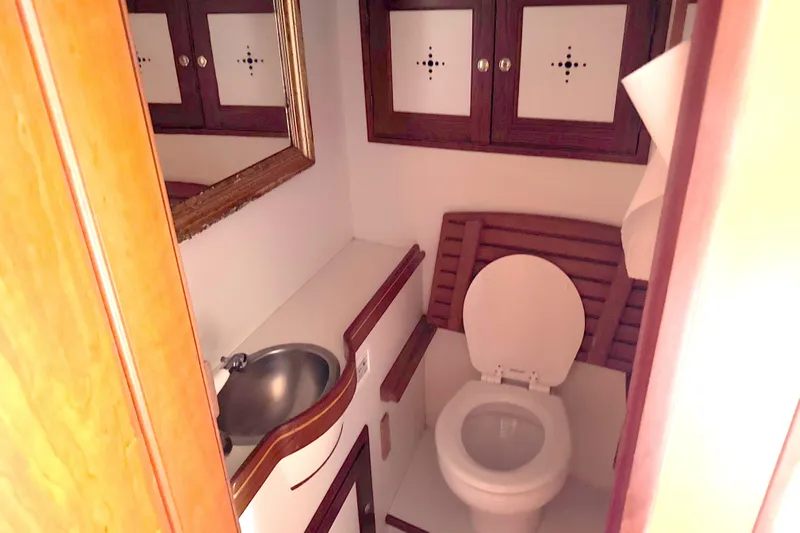 Mara Yacht Photos Pics 1998 Able Apogee 50 yacht bathroom with wooden cabinets and compact sink.