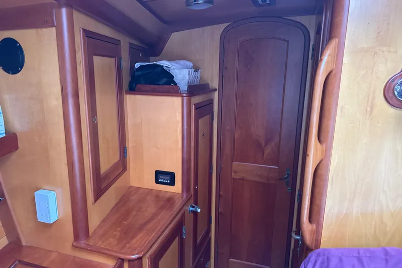 Mara Yacht Photos Pics Interior of 1998 Able Apogee 50 sailboat with wooden cabinetry and door.