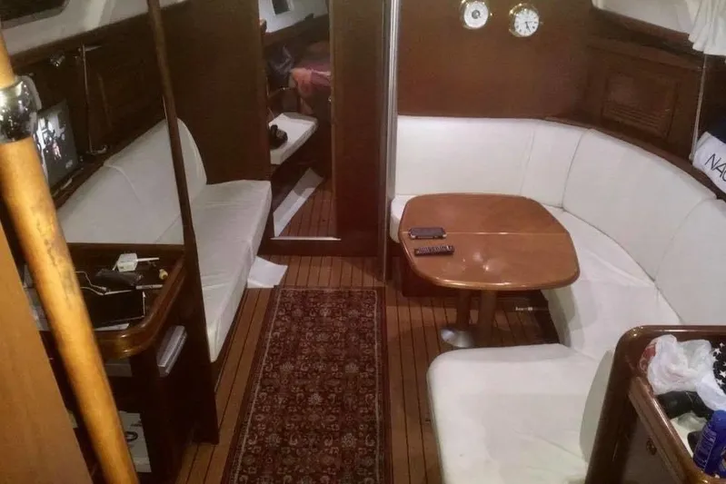 Yacht Photos Pics Interior of 2003 Beneteau Oceanis Clipper 423 yacht with cozy seating and wooden finishes.