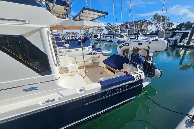 Tuva- B - Lu Yacht Photos Pics 2015 Cutwater 30 Command Bridge yacht docked in a marina, featuring a spacious deck.