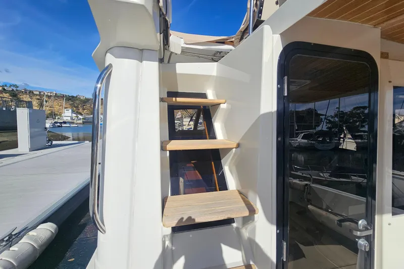 Tuva- B - Lu Yacht Photos Pics Staircase on 2015 Cutwater 30 Command Bridge yacht, leading to upper deck, docked at marina.