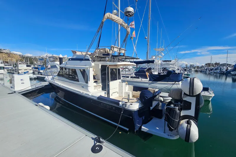 Tuva- B - Lu Yacht Photos Pics 2015 Cutwater 30 Command Bridge docked at a marina under clear blue skies.