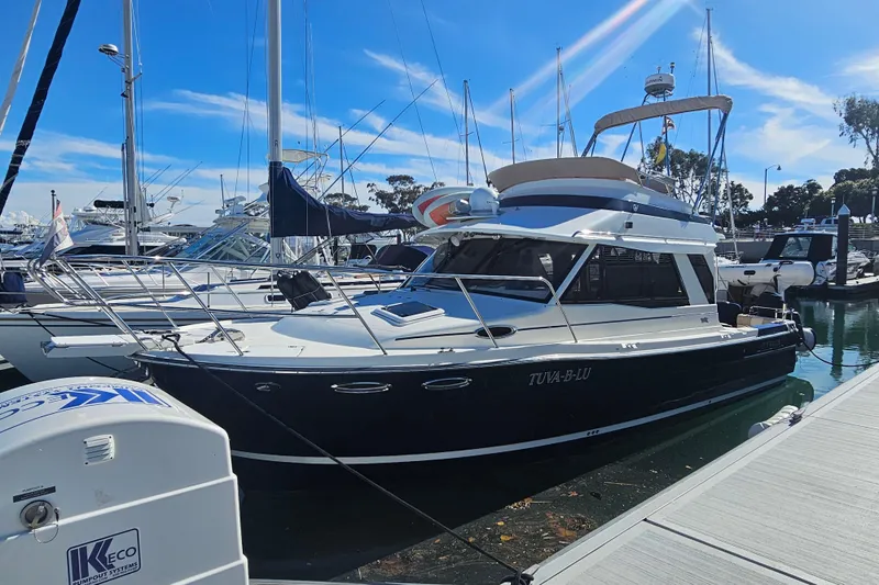 Tuva- B - Lu Yacht Photos Pics 2015 Cutwater 30 Command Bridge yacht docked at marina under clear blue sky.