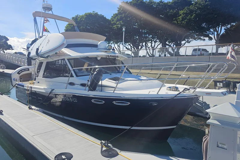 Tuva- B - Lu Yacht Photos Pics 2015 Cutwater 30 Command Bridge docked at marina under clear sky.