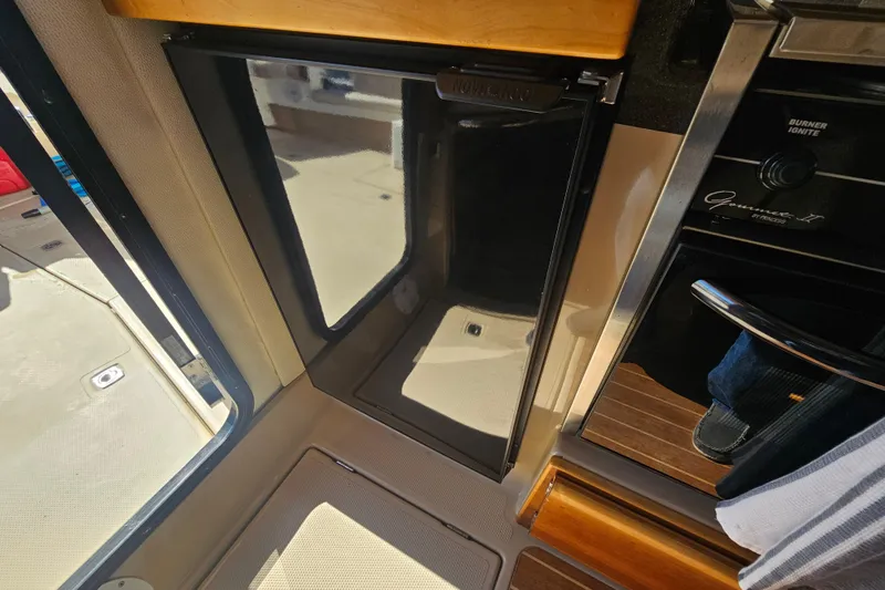 Tuva- B - Lu Yacht Photos Pics Interior of a 2015 Cutwater 30 Command Bridge boat, featuring a compact kitchen area.