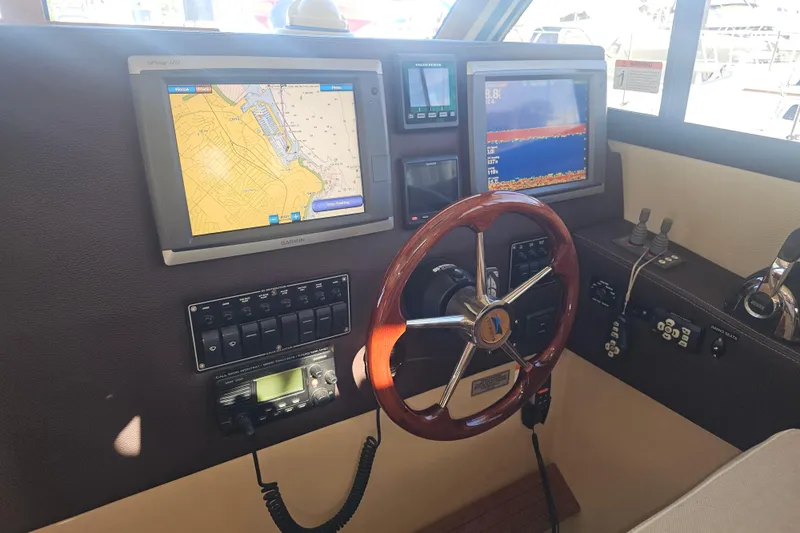 Tuva- B - Lu Yacht Photos Pics Helm of 2015 Cutwater 30 Command Bridge with navigation screens and controls.