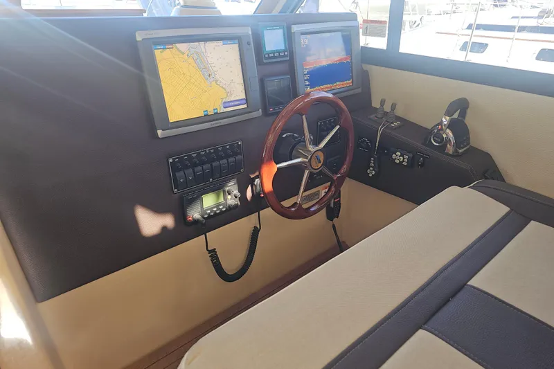 Tuva- B - Lu Yacht Photos Pics Helm of 2015 Cutwater 30 Command Bridge with navigation screens and controls.
