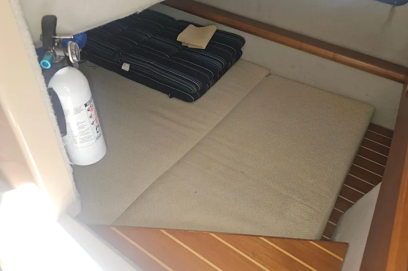 Tuva- B - Lu Yacht Photos Pics 2015 Cutwater 30 Command Bridge cabin interior with fire extinguisher and bedding.