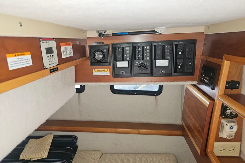 Tuva- B - Lu Yacht Photos Pics Interior view of 2015 Cutwater 30 Command Bridge with control panels and seating area.