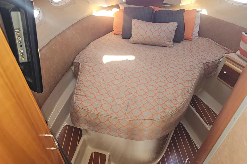 Tuva- B - Lu Yacht Photos Pics 2015 Cutwater 30 Command Bridge cabin with cozy bed and patterned bedding.