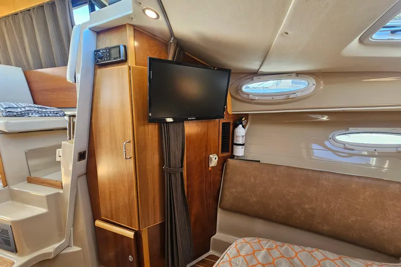 Tuva- B - Lu Yacht Photos Pics Interior of 2015 Cutwater 30 Command Bridge with TV, seating, and portholes.