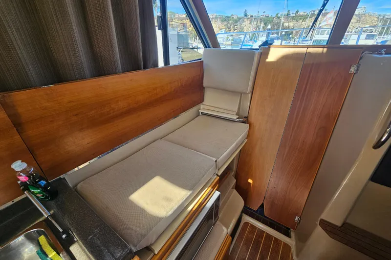 Tuva- B - Lu Yacht Photos Pics Interior of 2015 Cutwater 30 Command Bridge with cushioned seating and wooden accents.