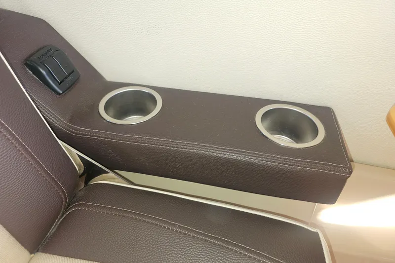 Tuva- B - Lu Yacht Photos Pics Brown leather armrest with dual cup holders in a 2015 Cutwater 30 Command Bridge.