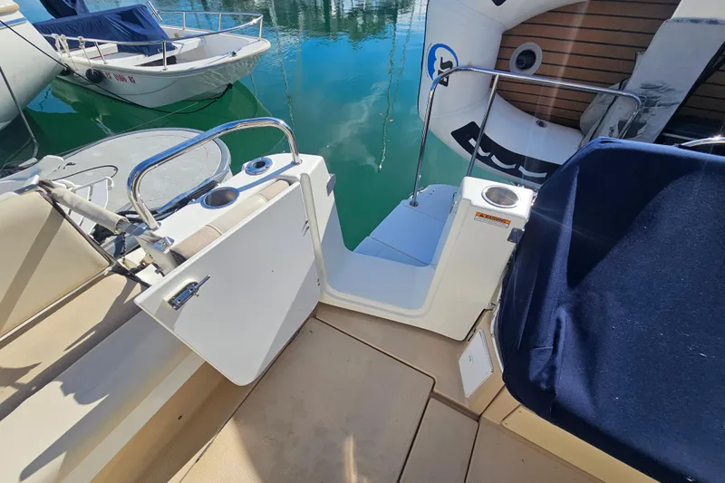 Tuva- B - Lu Yacht Photos Pics 2015 Cutwater 30 Command Bridge boat deck with open gate and water view.