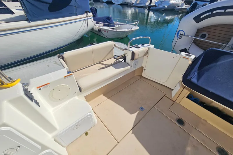 Tuva- B - Lu Yacht Photos Pics 2015 Cutwater 30 Command Bridge boat interior with seating and docked at marina.